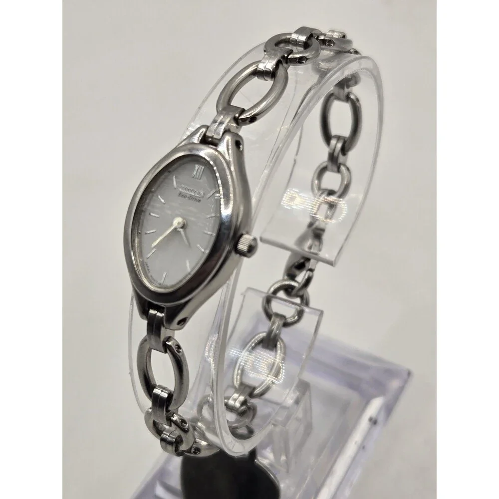 Citizen Eco-Drive Oval Silver Tone White Dial Heart Charm Bracelet Watch.